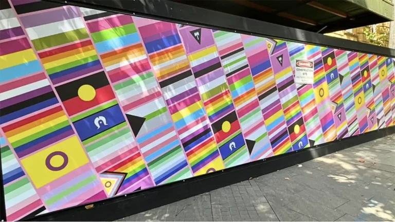 High-resolution vinyl hoarding banner installed on a construction site with vibrant branding